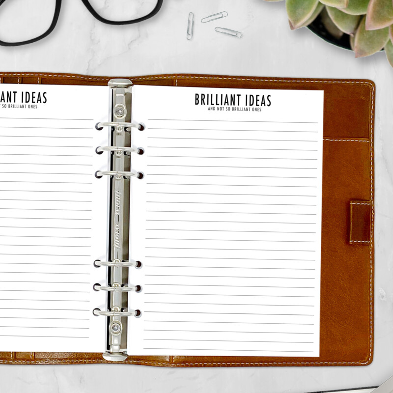 Creative planner insert inside binder with pen and office supplies