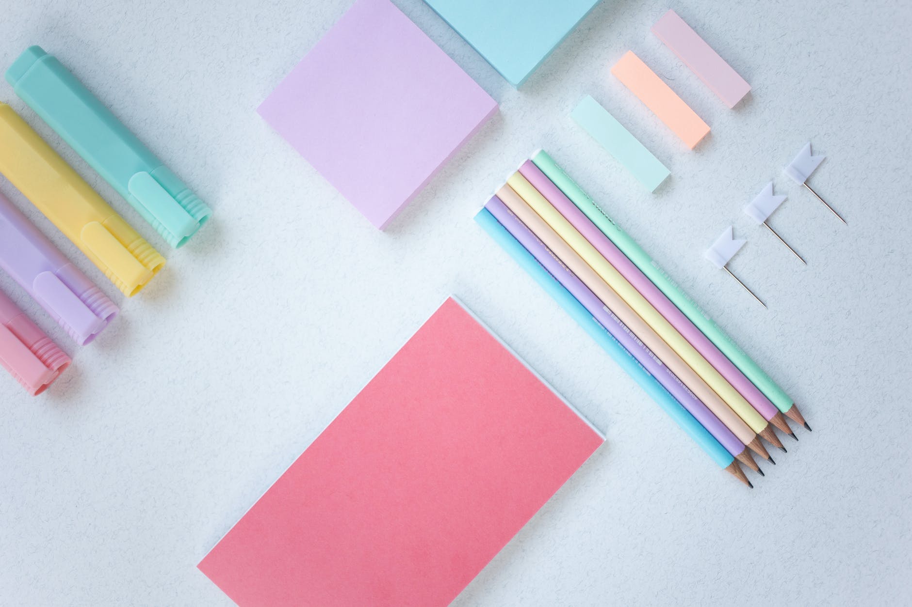 organized stationery items on white surface