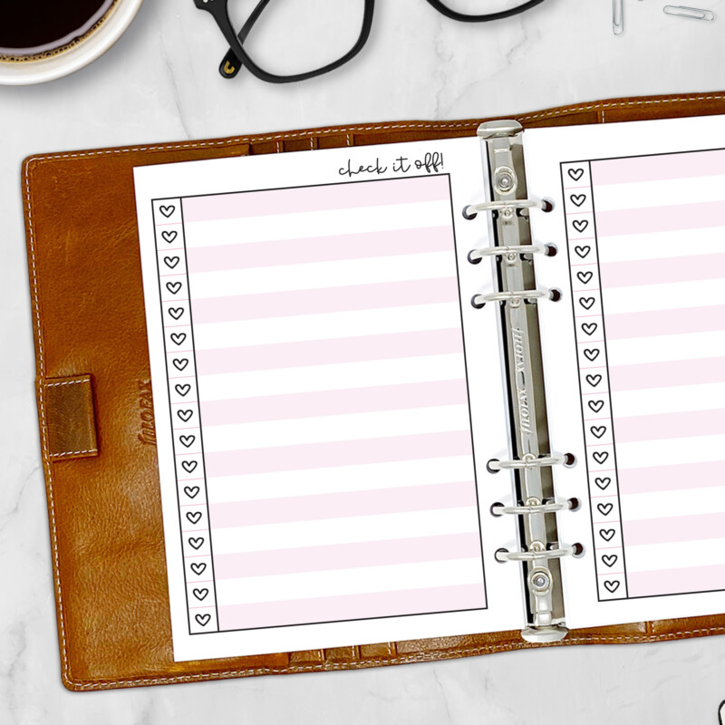 Colorful heart checklist insert shown inside ring-bound planner with pen