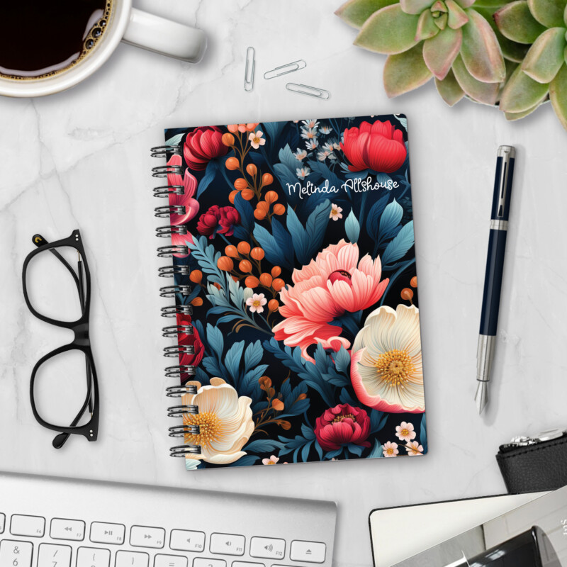 Personalized hardcover notebook in Dark Jewels design with moody floral peonies and poppies on navy background styled on marble desk with coffee and pen
