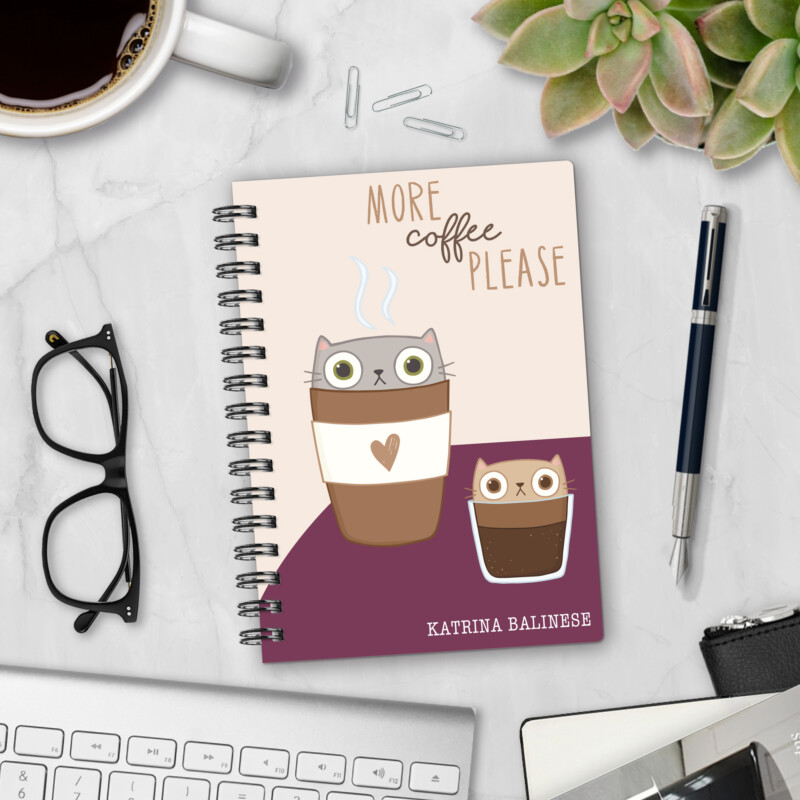 Personalized hardcover notebook in Espurrresso Yourself design with cute cartoon cats in coffee cups and More Coffee Please text on marble desk with pen