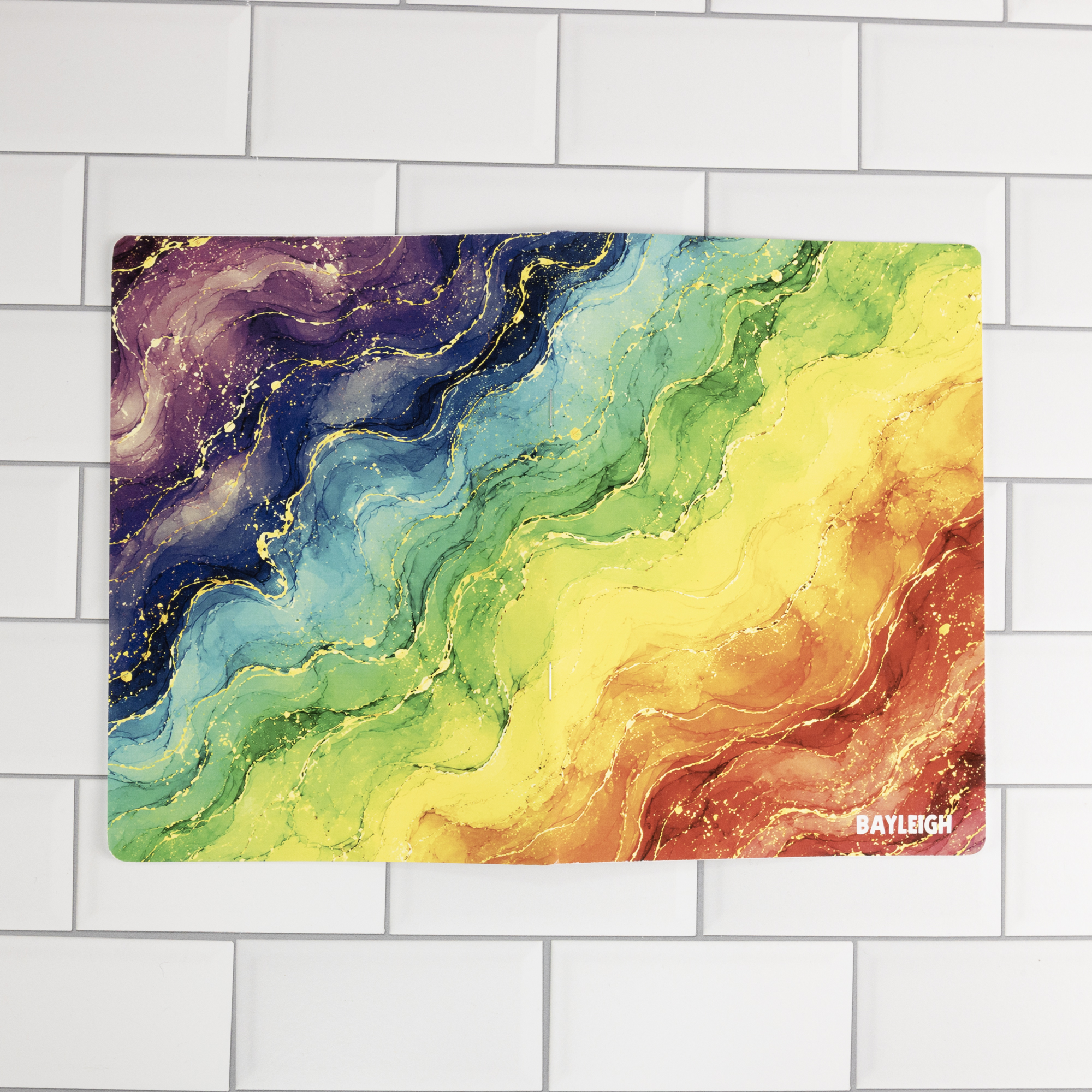 Prism personalized traveler's notebook insert cover flat-lay showing rainbow watercolor marble with personalized name in white text.