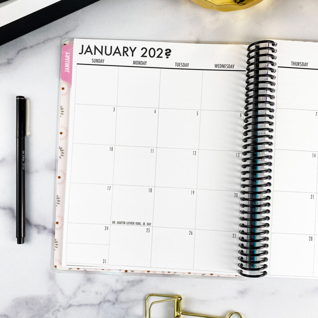 7x9 planner open to a two-page dated January calendar spread with notes column.