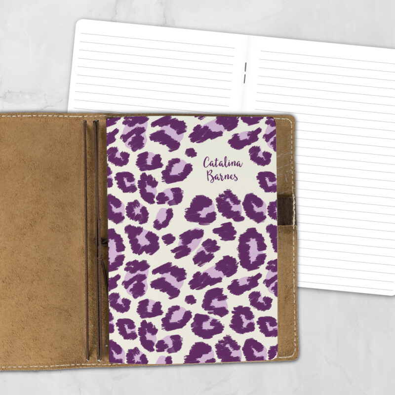 A5 Electric Prowl personalized traveler's notebook refill showing the cover design inside a leather traveler's notebook cover, with lined refill pages visible behind.