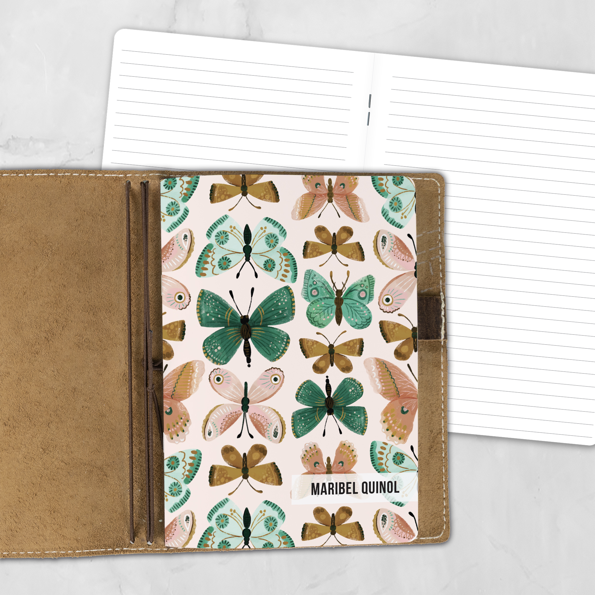 A5 Flutter By lifestyle personalized traveler's notebook refill showing the cover design inside a leather traveler's notebook cover, with lined refill pages visible behind.