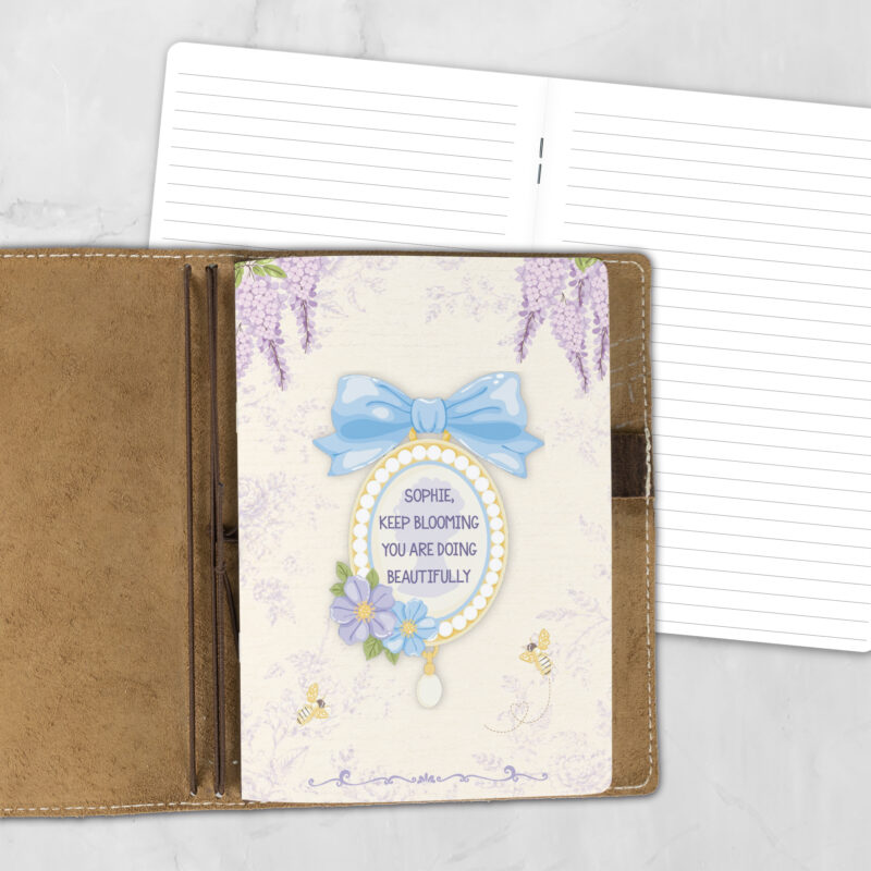 A5 Garden Tea personalized traveler's notebook refill showing the cover design inside a leather traveler's notebook cover, with lined refill pages visible behind.