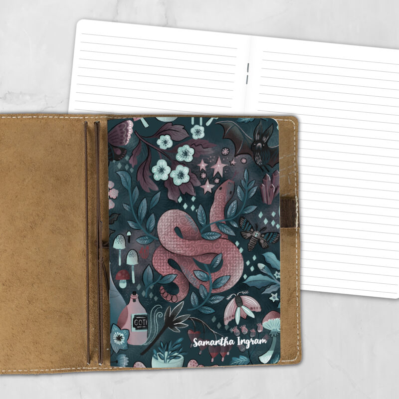 A5 Into the Night lifestyle personalized traveler's notebook refill showing the cover design inside a leather traveler's notebook cover, with lined refill pages visible behind.