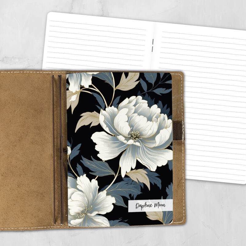 A5 Midnight Bloom Lifestyle personalized traveler's notebook refill showing the cover design inside a leather traveler's notebook cover, with lined refill pages visible behind.