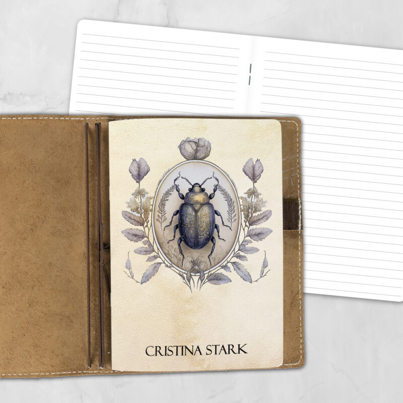 A5 Momento Insecta personalized traveler's notebook refill showing the cover design inside a leather traveler's notebook cover, with lined refill pages visible behind.