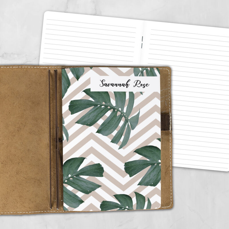 A5 Monstera Summer personalized traveler's notebook refill showing the cover design inside a leather traveler's notebook cover, with lined refill pages visible behind.