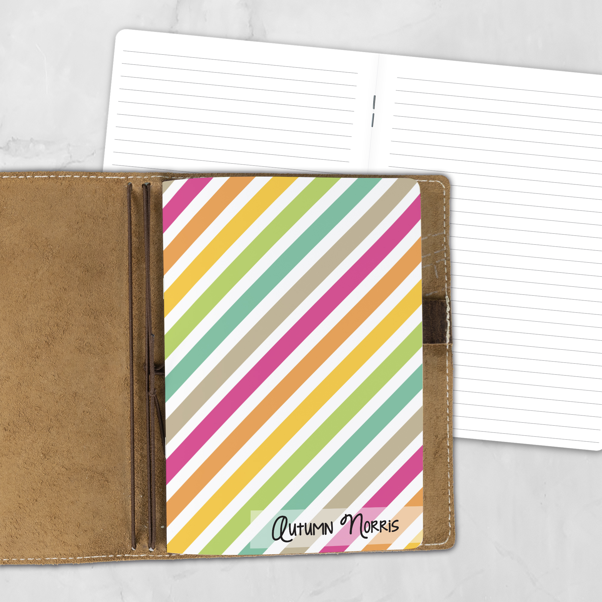 A5 Stripe Hype personalized traveler's notebook refill showing the cover design inside a leather traveler's notebook cover, with lined refill pages visible behind.