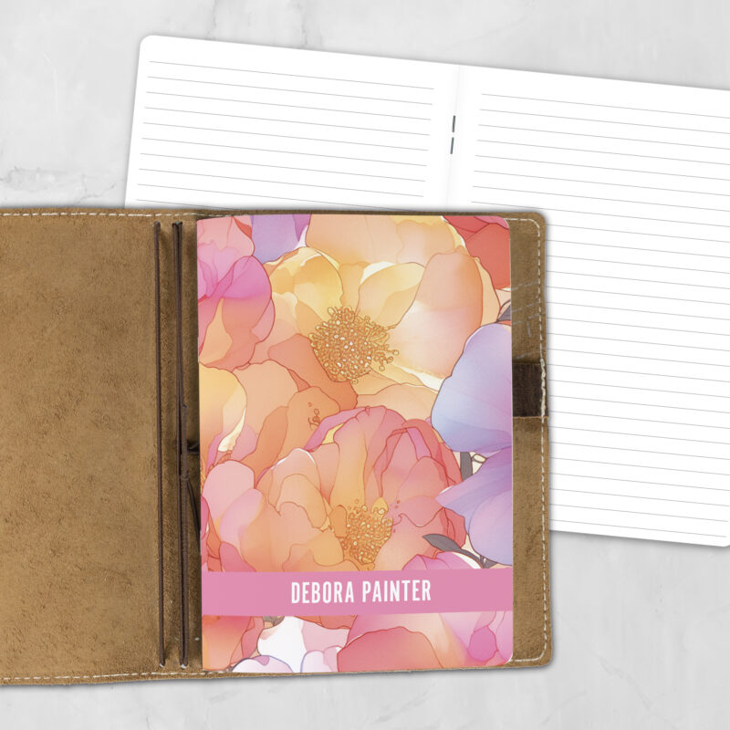 A5 Sunset Blooms personalized traveler's notebook refill showing the cover design inside a leather traveler's notebook cover, with lined refill pages visible behind.