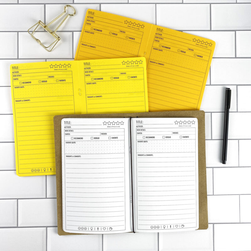 Book Review traveler's notebook refill by CityGirl Planners, showing book review journal pages for tracking reading and notes. Three booklets displayed in different paper color options inside a traveler's notebook cover.
