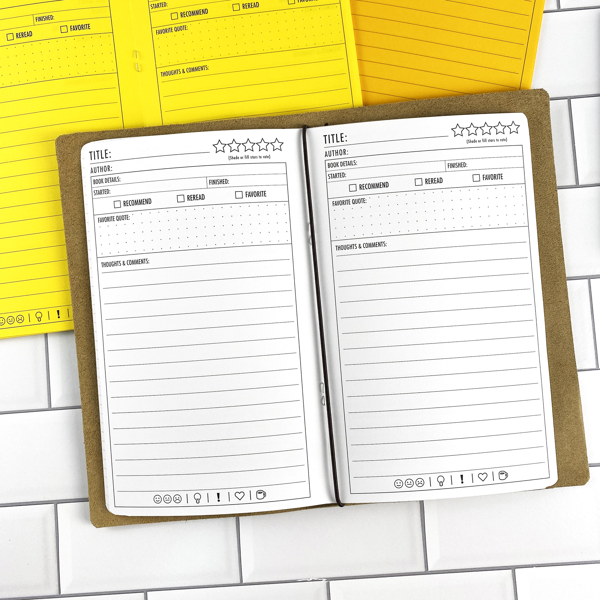Book Review traveler's notebook refill opened to show the book review journal pages for tracking reading and notes in bright white paper, saddle-stitched booklet format.