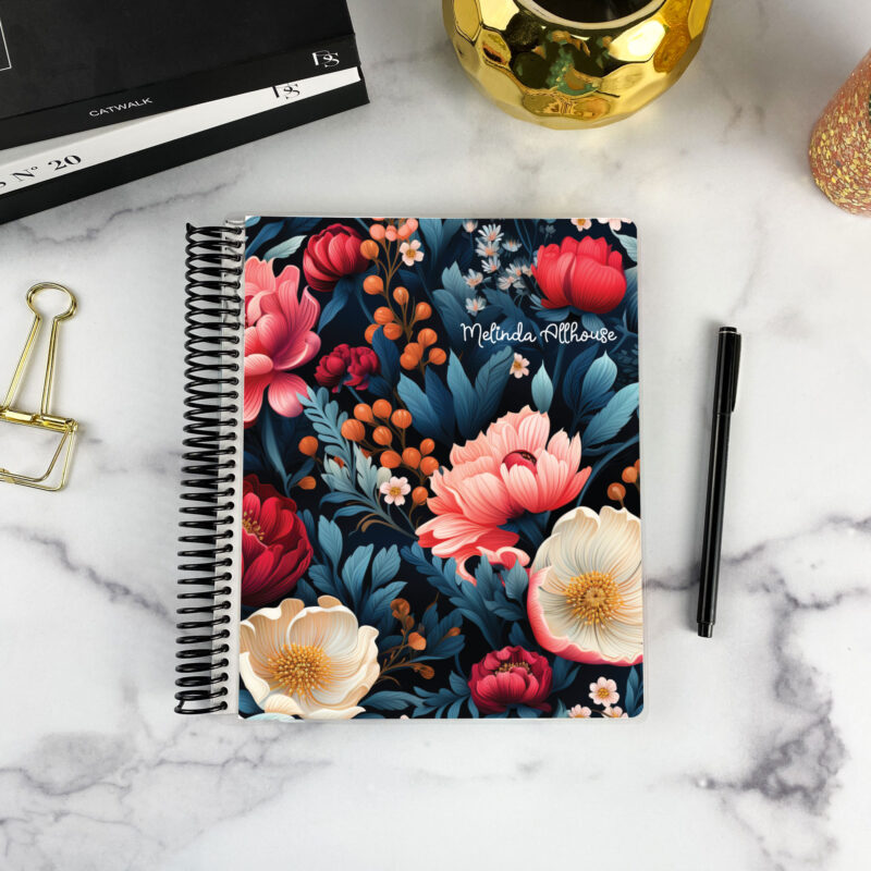 7x9 spiral bound planner in the Dark Jewels cover design on a marble surface with styling accessories.