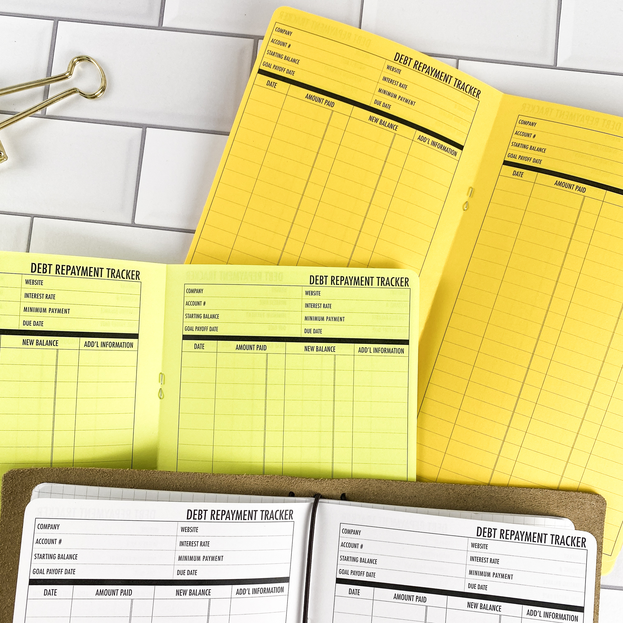 Debt Repayment traveler's notebook refill showing the full page spread with debt repayment tracker pages for managing payoff progress in a contrasting paper color.