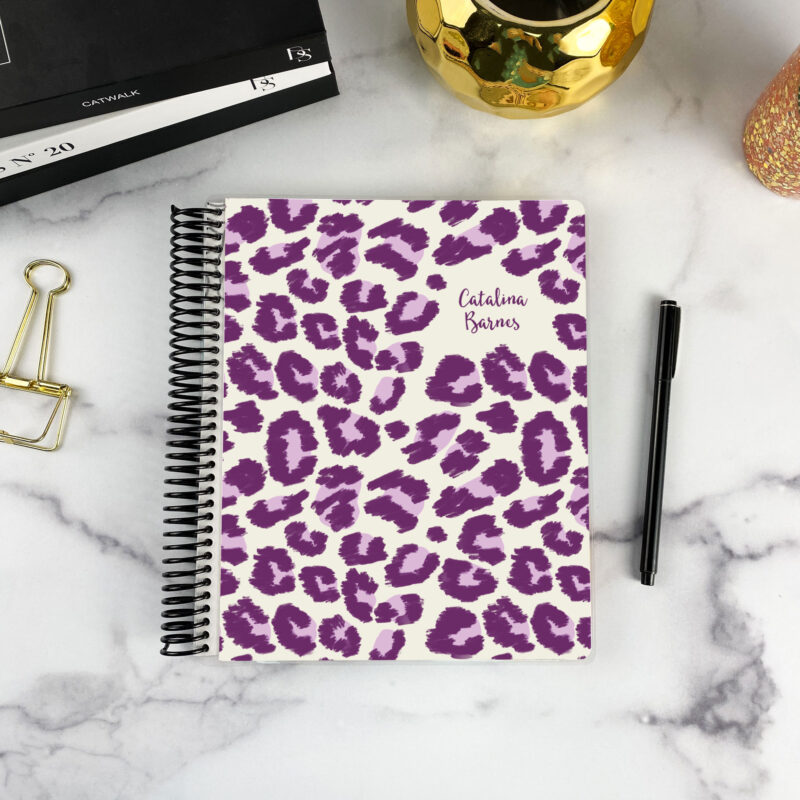 7x9 spiral bound planner in the Electric Prowl cover design on a marble surface with styling accessories.
