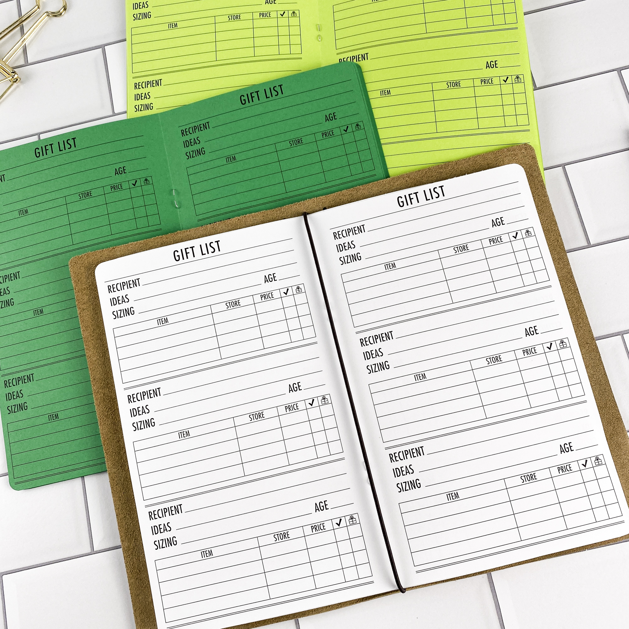 Close-up detail of the Gift List traveler's notebook refill showing the page layout and gift list planning pages for tracking gift ideas and budgets in colored paper.
