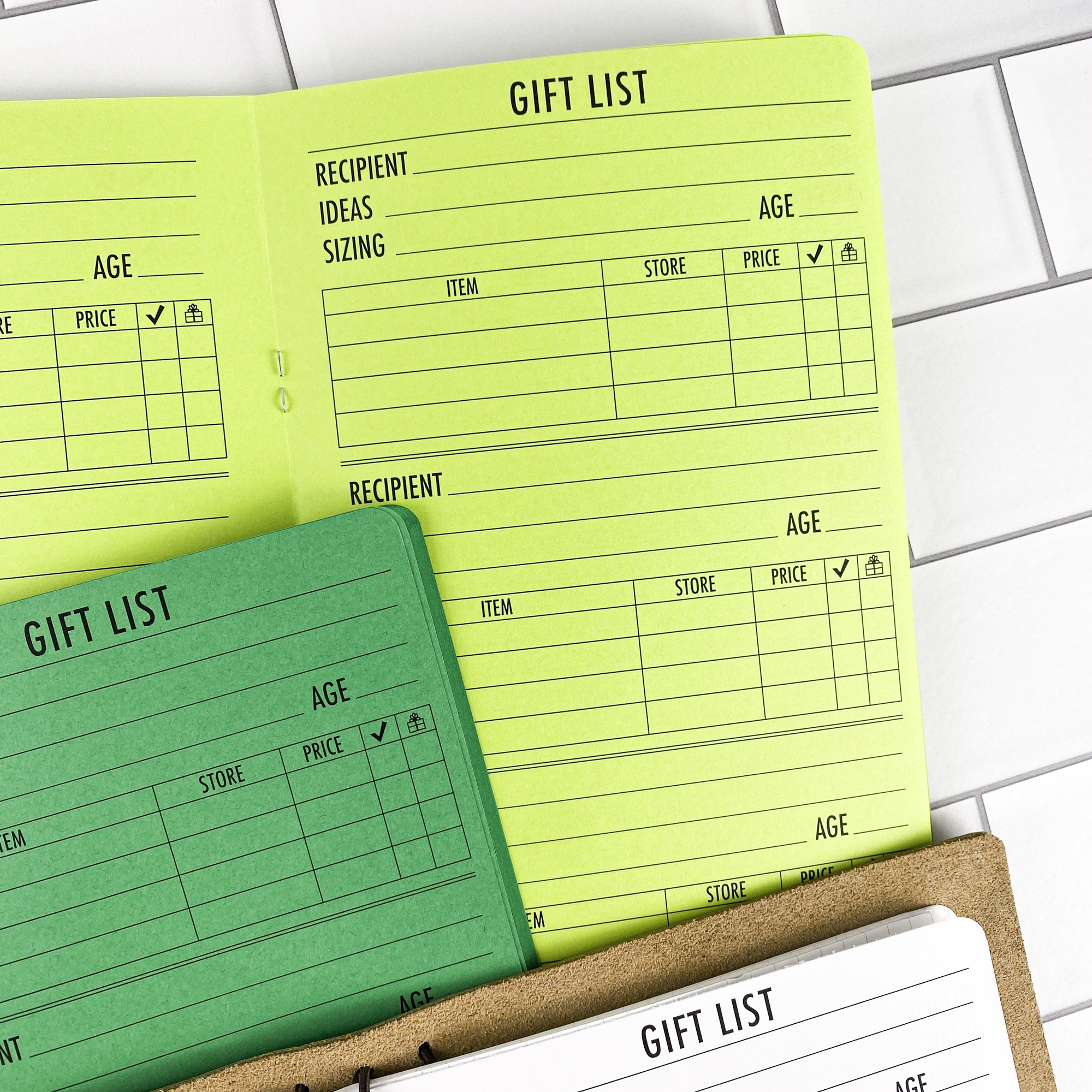 Detail view of the Gift List traveler's notebook refill showing gift list planning pages for tracking gift ideas and budgets, displayed with multiple paper color options.