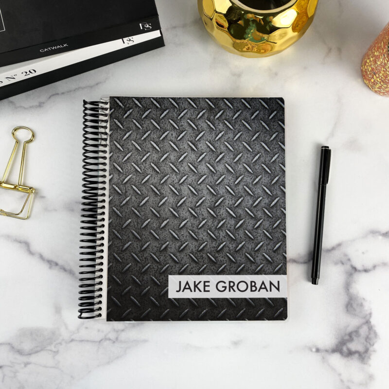 7x9 spiral bound planner in the Industrial Strength cover design on a marble surface with styling accessories.