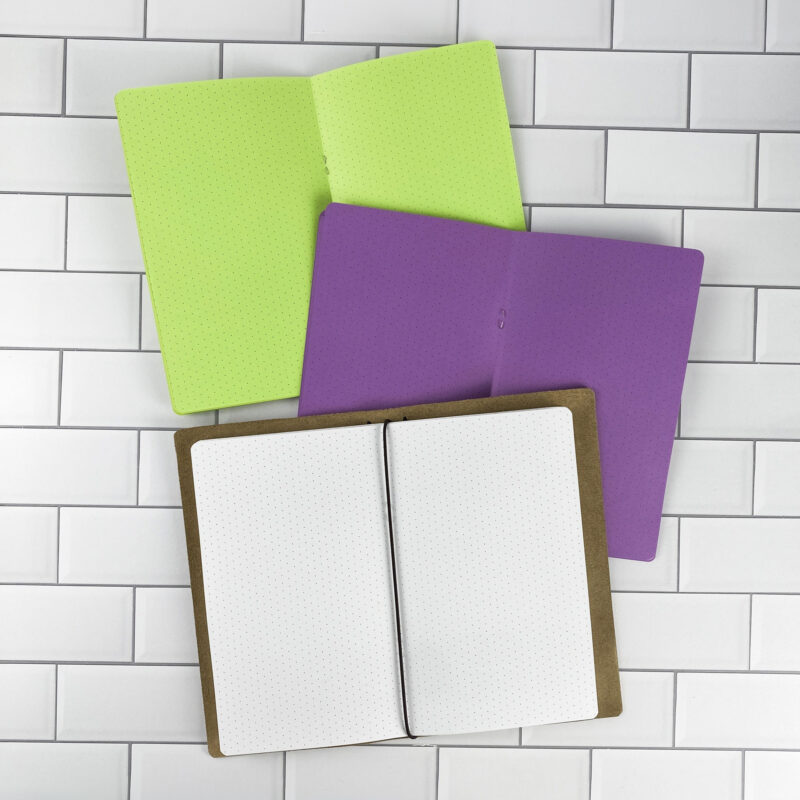 Isometric Dots traveler's notebook refill opened to show the isometric dot grid pages for 3D sketching and technical drawing in bright white paper, saddle-stitched booklet format.