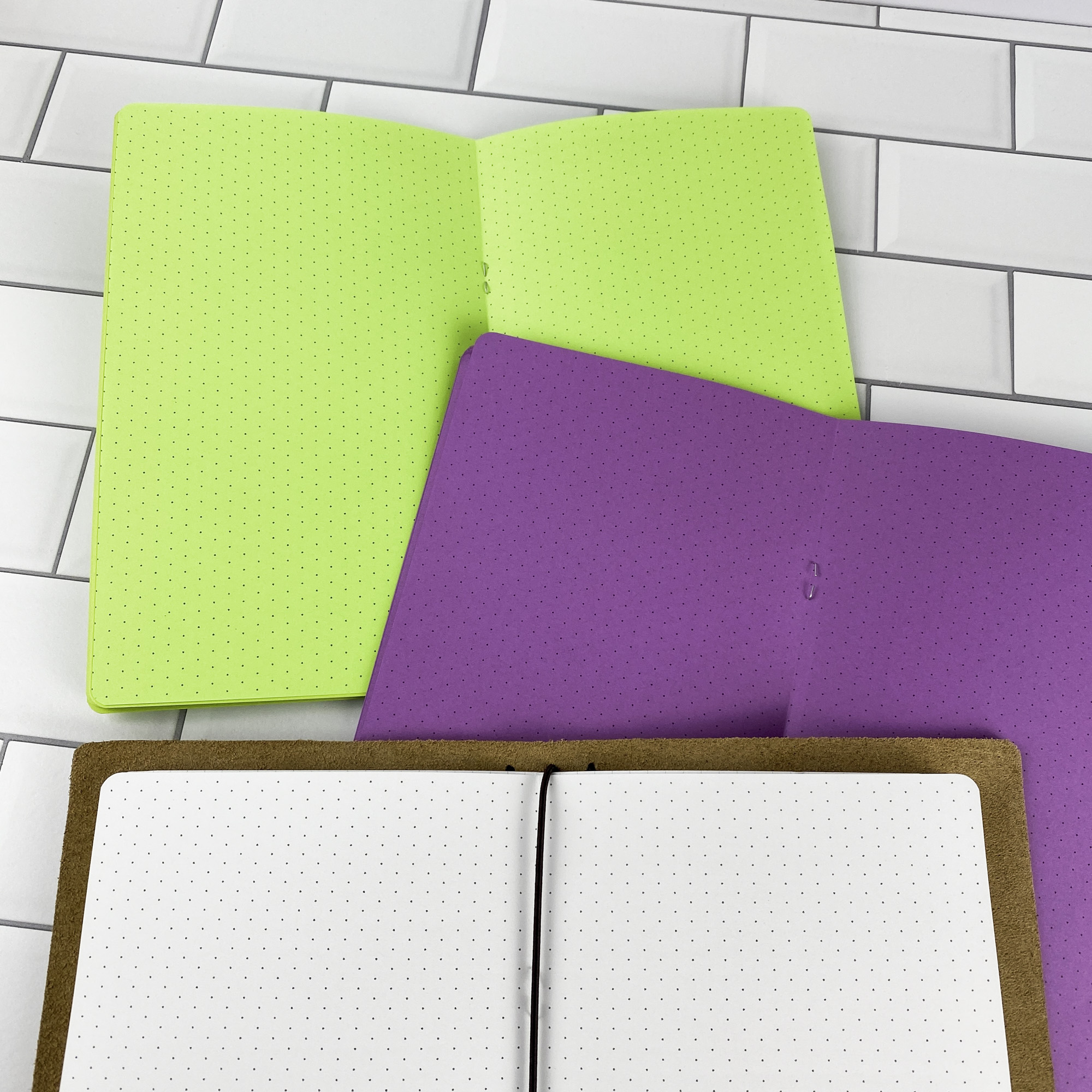 Close-up detail of the Isometric Dots traveler's notebook refill showing the page layout and isometric dot grid pages for 3D sketching and technical drawing in colored paper.