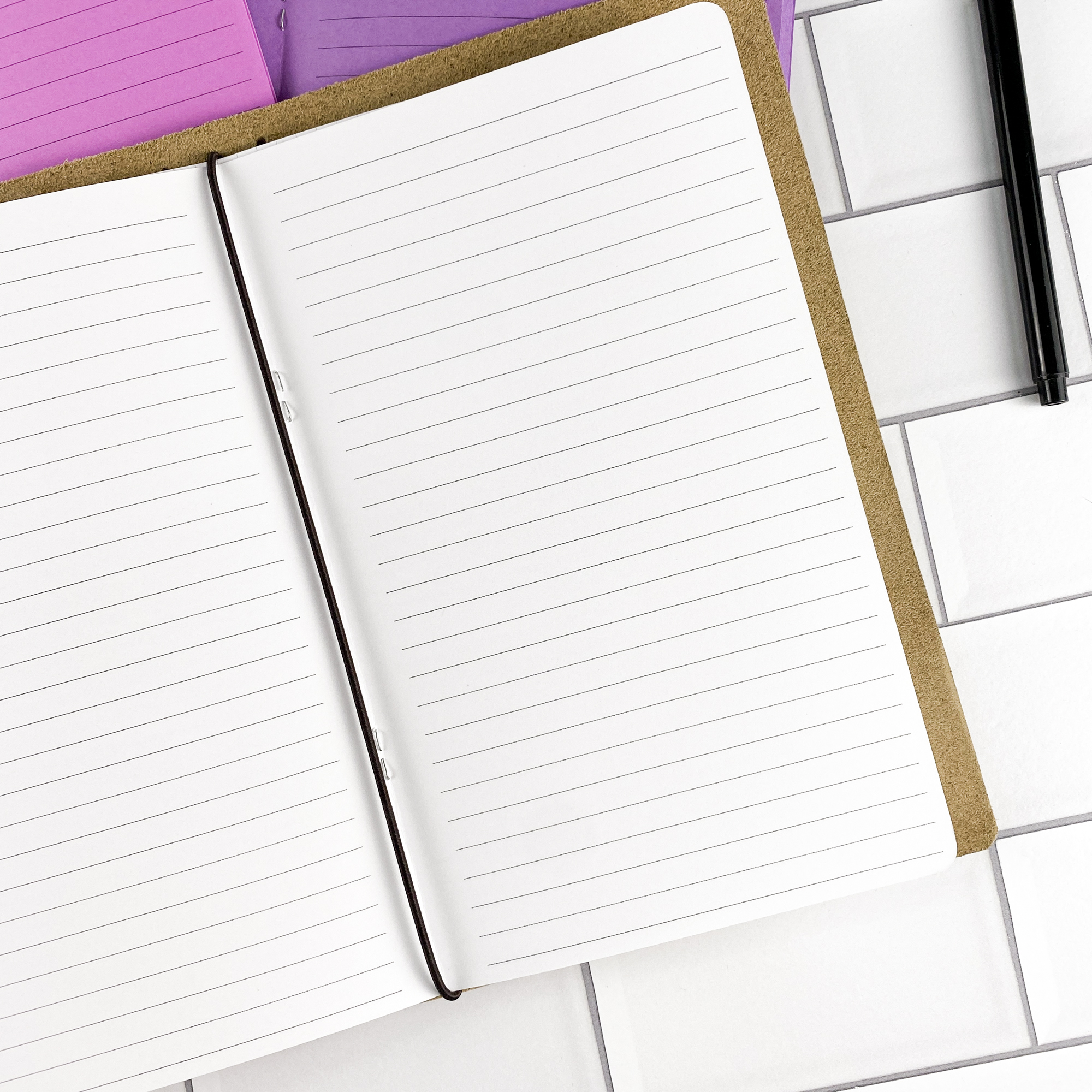 Close-up detail of the Lined traveler's notebook refill showing the page layout and lined pages for everyday note taking in colored paper.