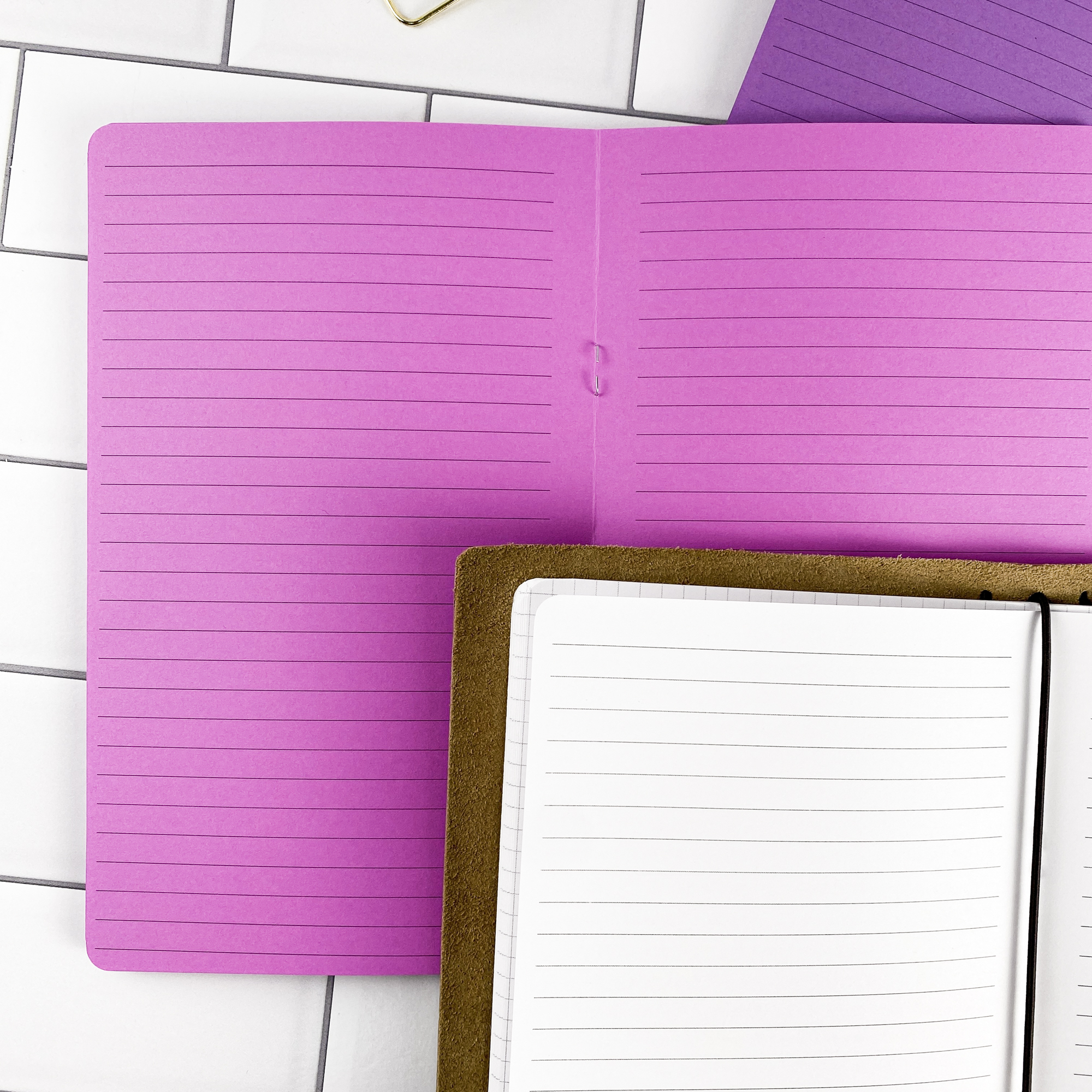Detail view of the Lined traveler's notebook refill showing lined pages for everyday note taking, displayed with multiple paper color options.