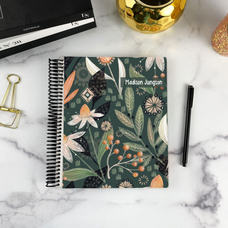 7x9 spiral bound planner in the Night Garden cover design on a marble surface with styling accessories.