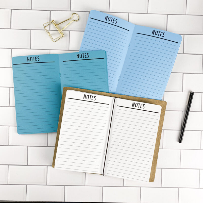 Notes traveler's notebook refill by CityGirl Planners, showing note-taking pages with a clean header design. Three booklets displayed in different paper color options inside a traveler's notebook cover.