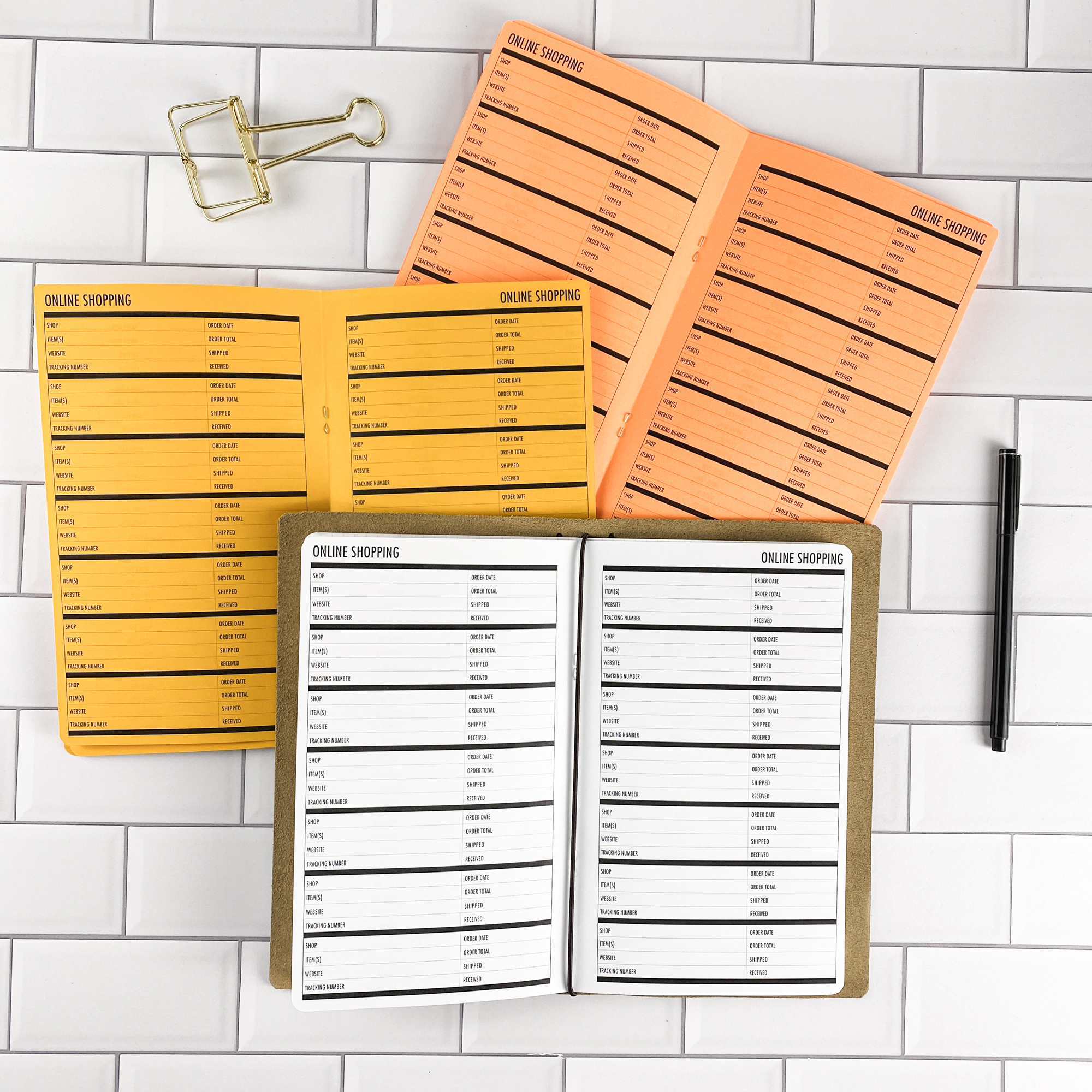 Online Shopping traveler's notebook refill by CityGirl Planners, showing online shopping tracker pages for managing orders and deliveries. Three booklets displayed in different paper color options inside a traveler's notebook cover.