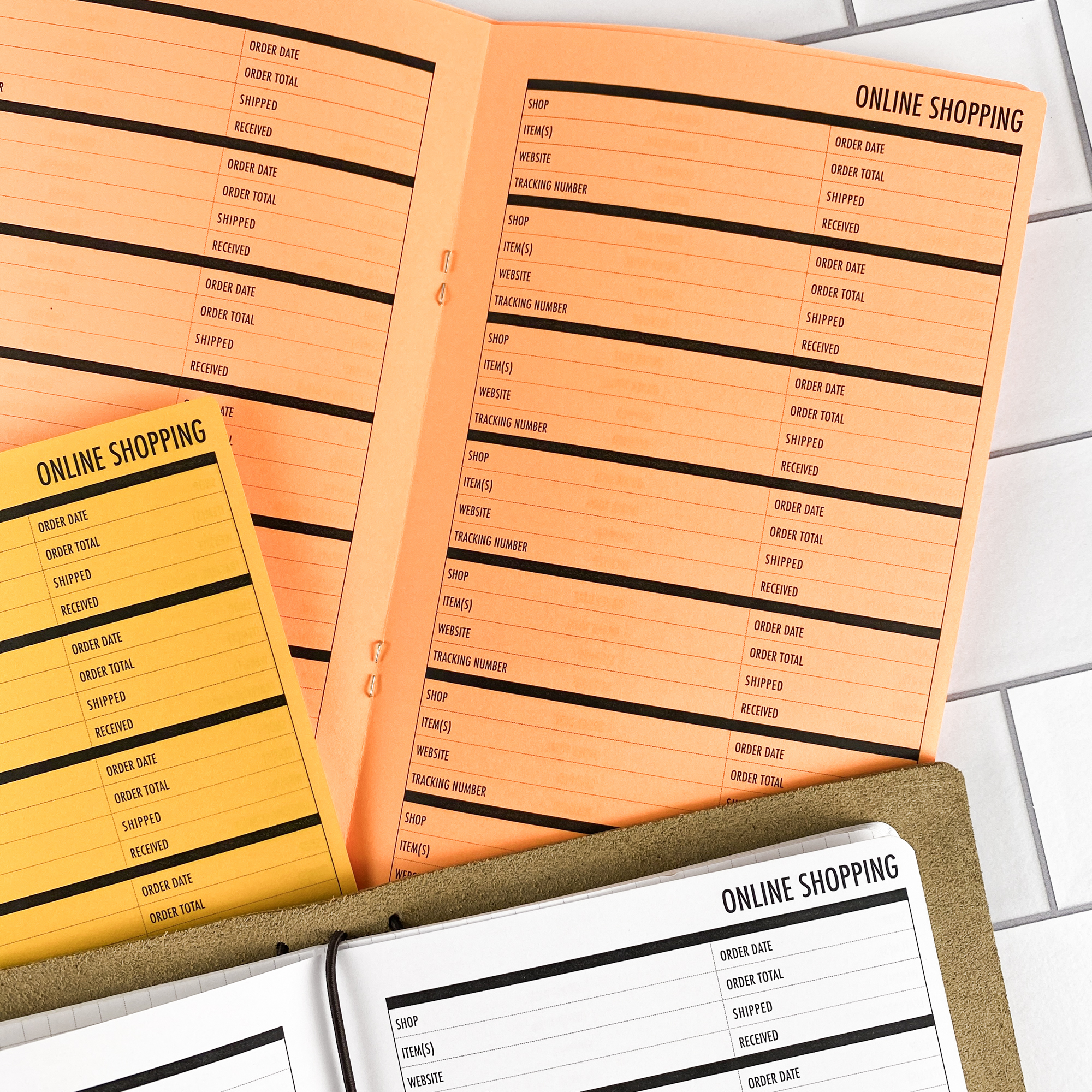 Detail view of the Online Shopping traveler's notebook refill showing online shopping tracker pages for managing orders and deliveries, displayed with multiple paper color options.