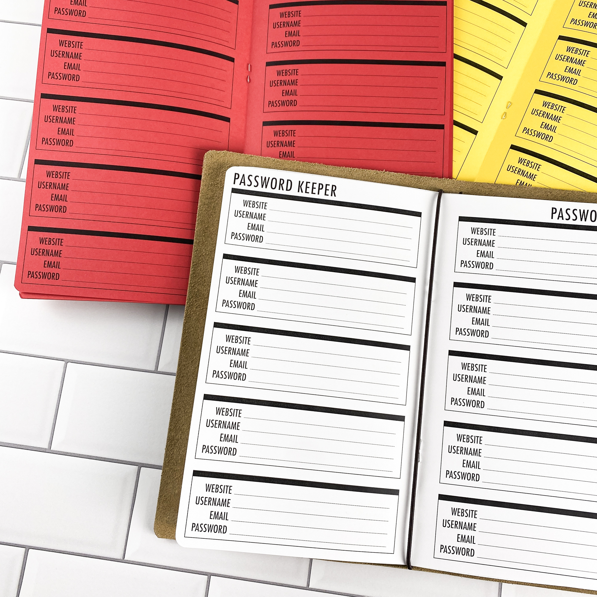 Password Keeper Boxes traveler's notebook refill opened to show the password keeper pages with a box layout for organizing login credentials in bright white paper, saddle-stitched booklet format.