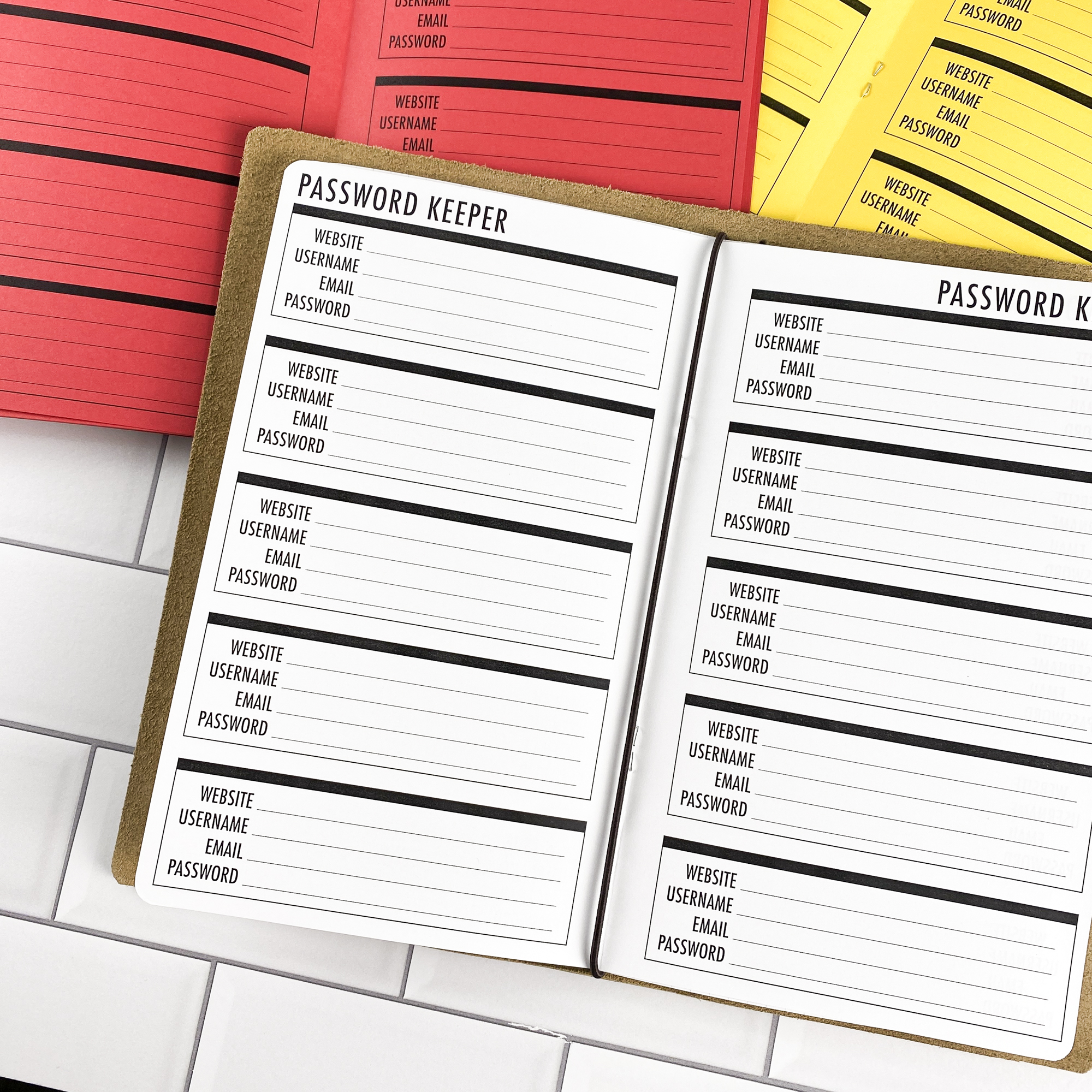 Close-up detail of the Password Keeper Boxes traveler's notebook refill showing the page layout and password keeper pages with a box layout for organizing login credentials in colored paper.