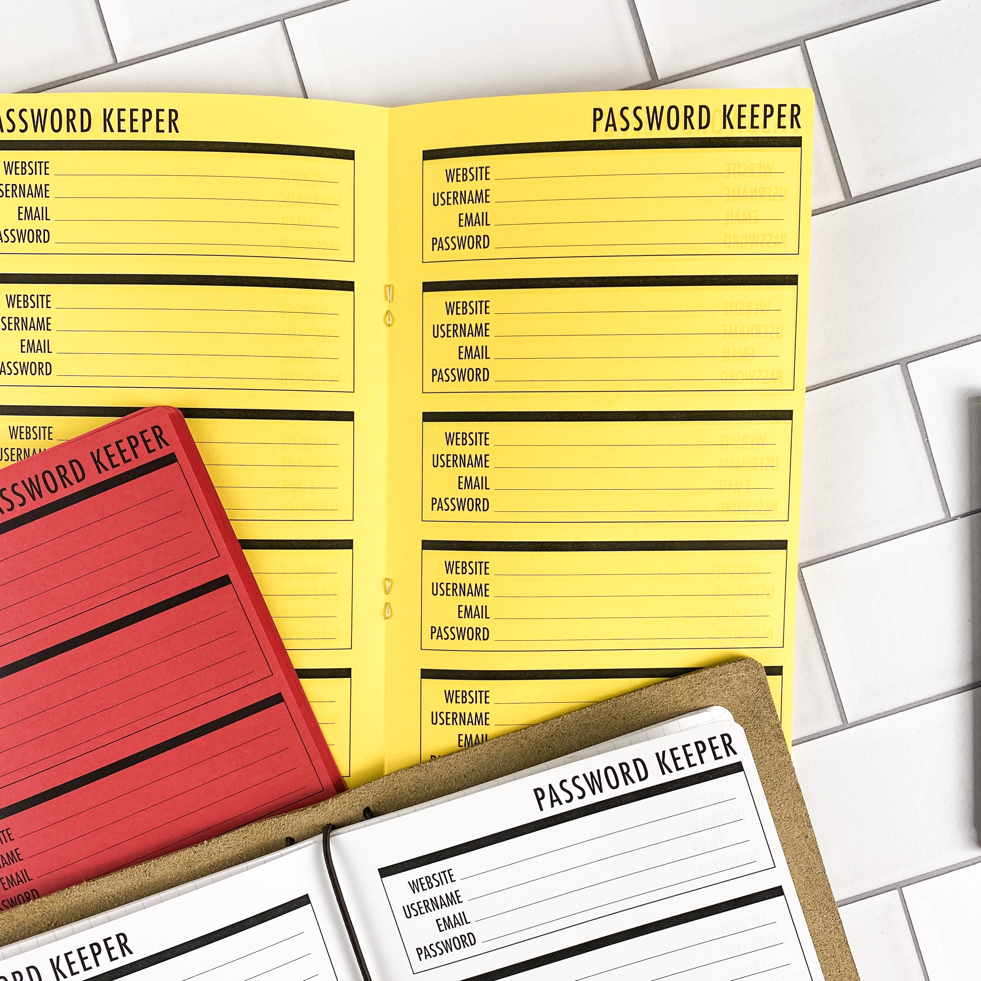 Close-up detail of the Password Keeper Boxes traveler's notebook refill showing the page layout and password keeper pages with a box layout for organizing login credentials in colored paper.
