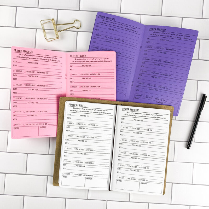 Prayer Requests traveler's notebook refill by CityGirl Planners, showing prayer request journal pages for recording prayers and answers. Three booklets displayed in different paper color options inside a traveler's notebook cover.