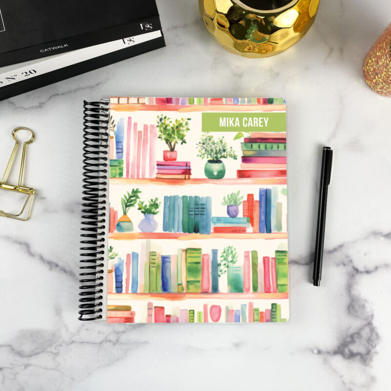 7x9 spiral bound planner in the Shelf control cover design on a marble surface with styling accessories.