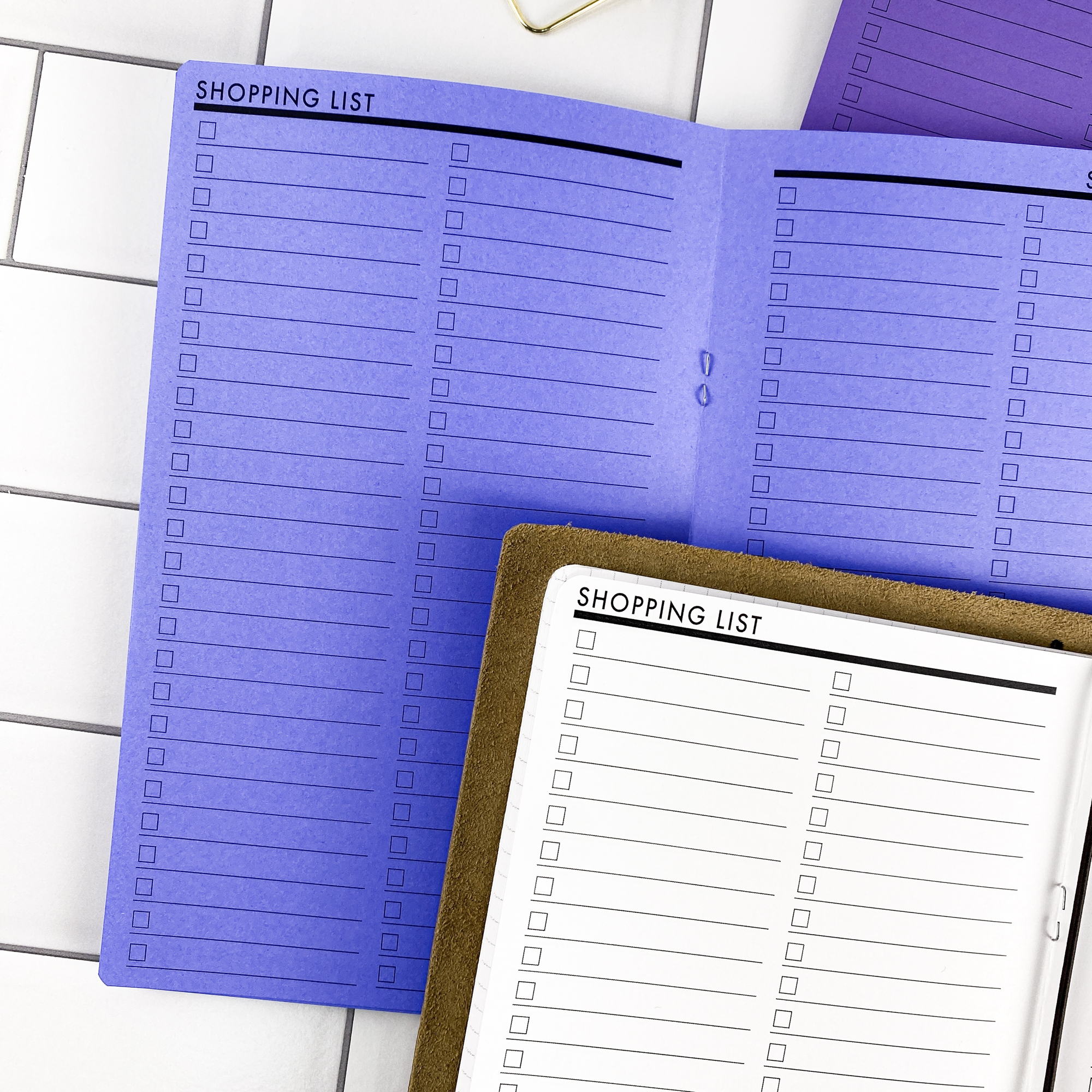 Close-up detail of the Shopping List traveler's notebook refill showing the page layout and shopping list pages for organizing grocery and errand lists in colored paper.