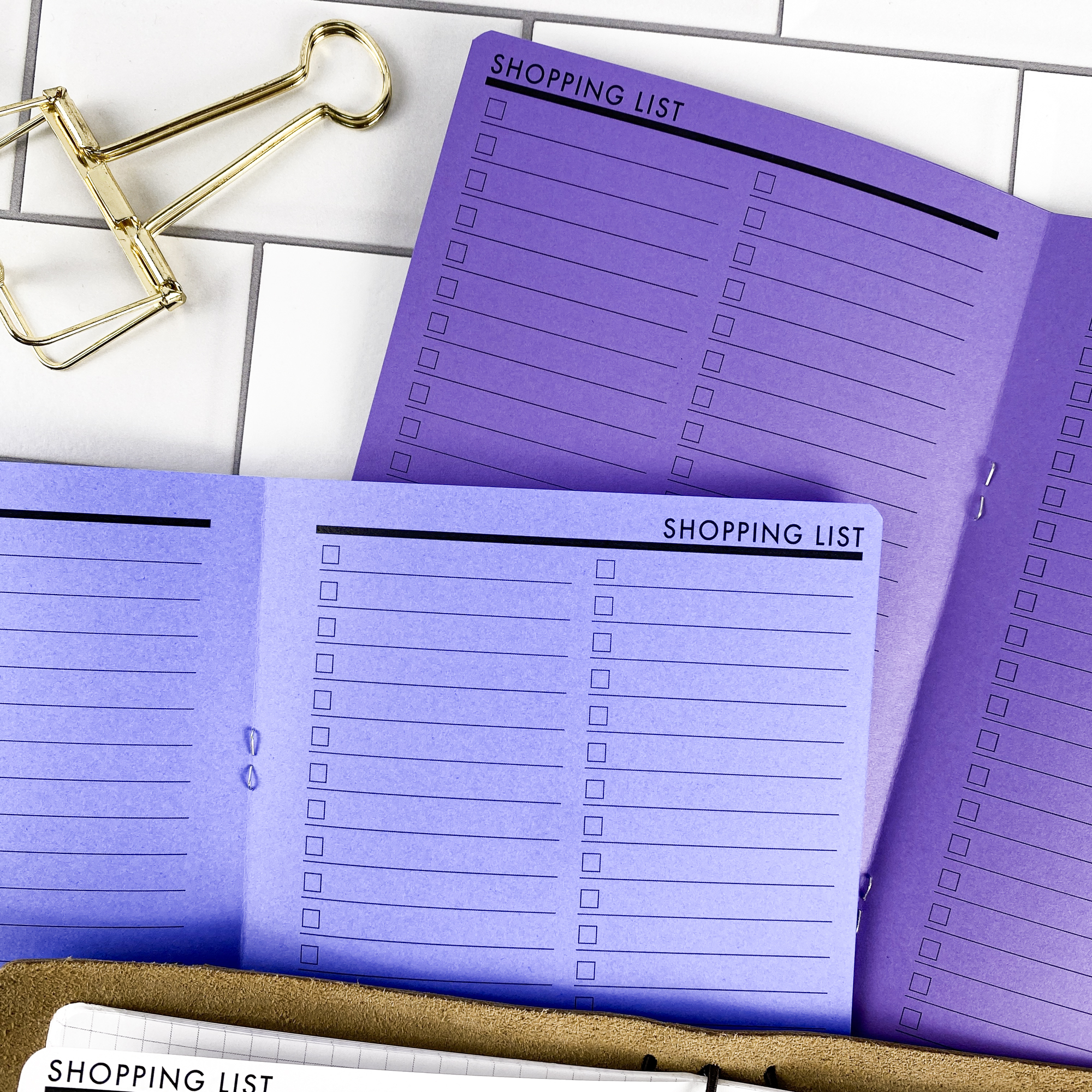 Detail view of the Shopping List traveler's notebook refill showing shopping list pages for organizing grocery and errand lists, displayed with multiple paper color options.