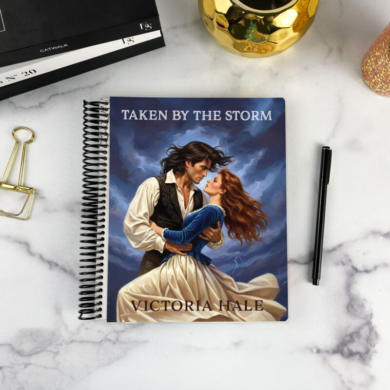 7x9 spiral bound planner in the Taken by the Storm cover design on a marble surface with styling accessories.