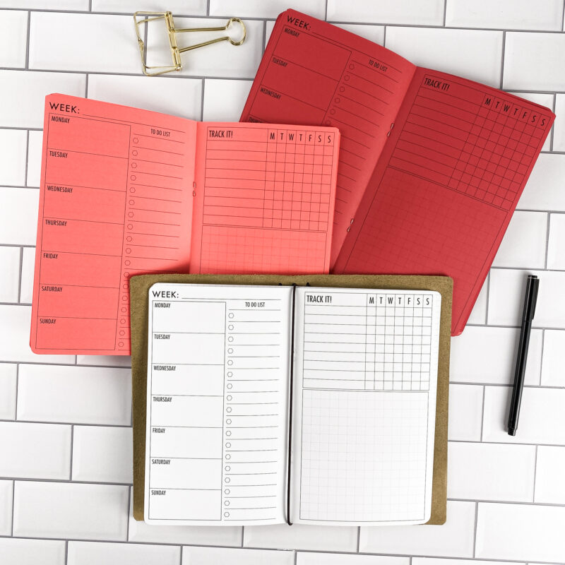 Week at a Glance traveler's notebook refill by CityGirl Planners, showing weekly planner spread showing a full week at a glance. Three booklets displayed in different paper color options inside a traveler's notebook cover.