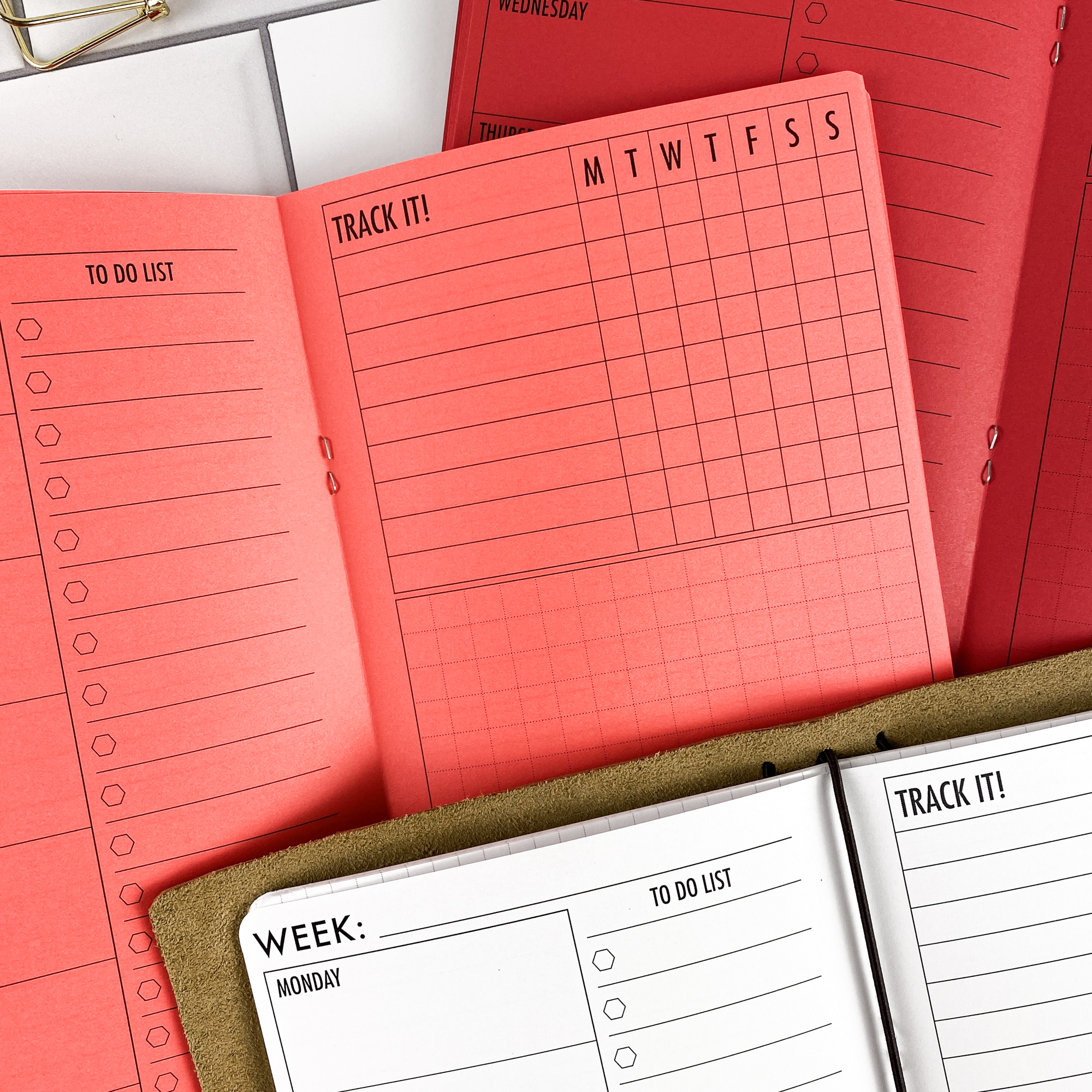 Detail view of the Week at a Glance traveler's notebook refill showing weekly planner spread showing a full week at a glance, displayed with multiple paper color options.