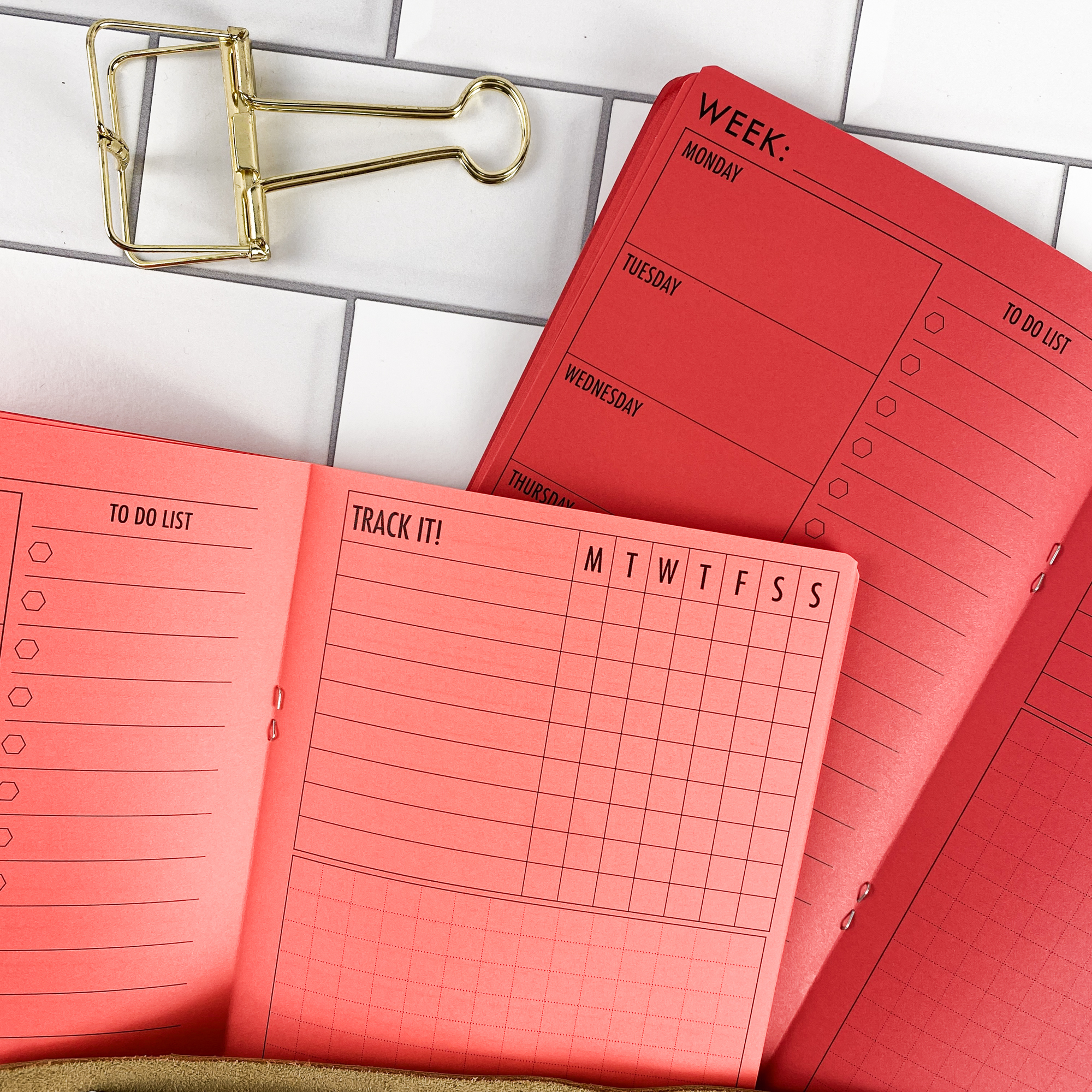 Week at a Glance traveler's notebook refill showing the full page spread with weekly planner spread showing a full week at a glance in a contrasting paper color.