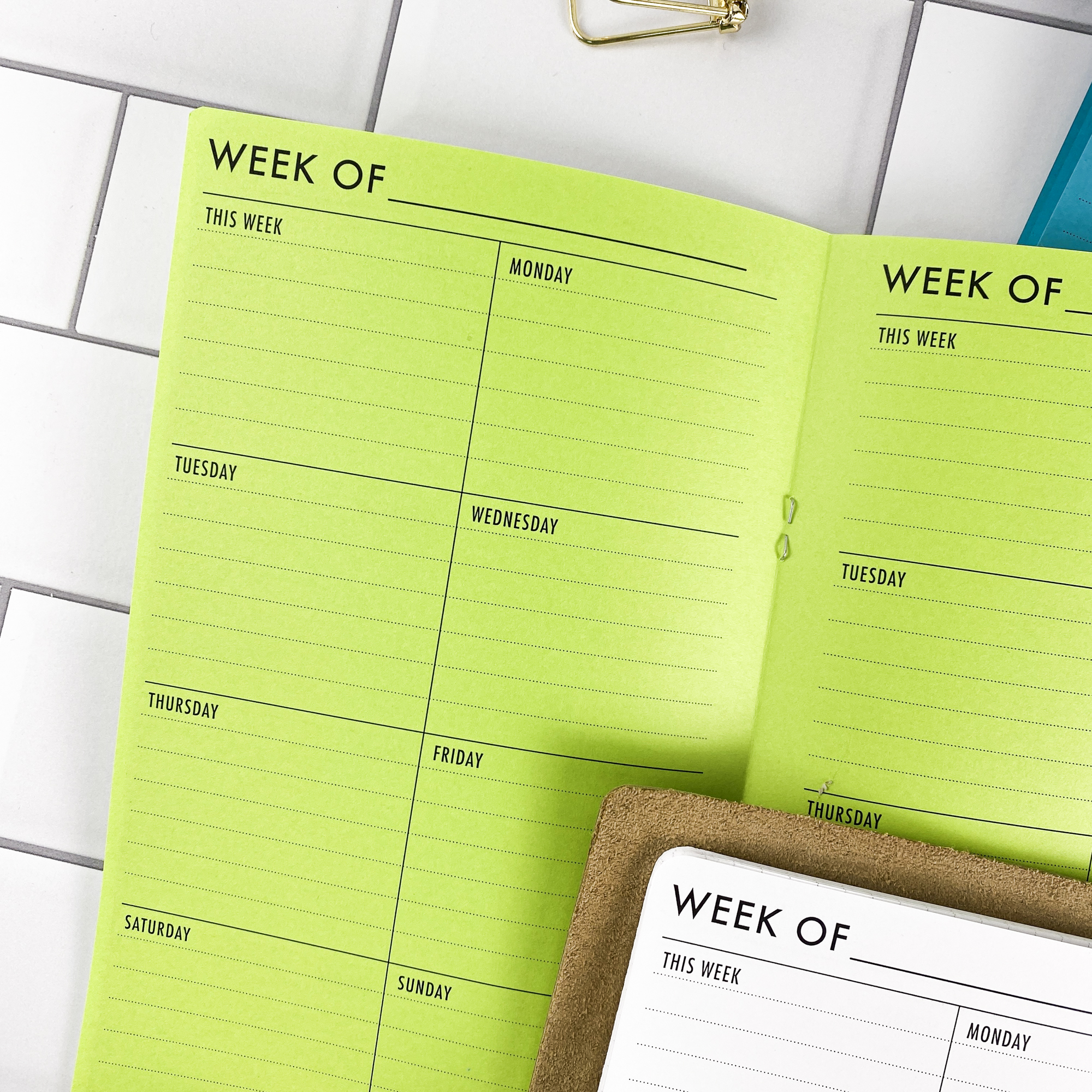 Close-up detail of the Week on 1 Page Vertical traveler's notebook refill showing the page layout and vertical weekly planner layout fitting a full week on one page in colored paper.