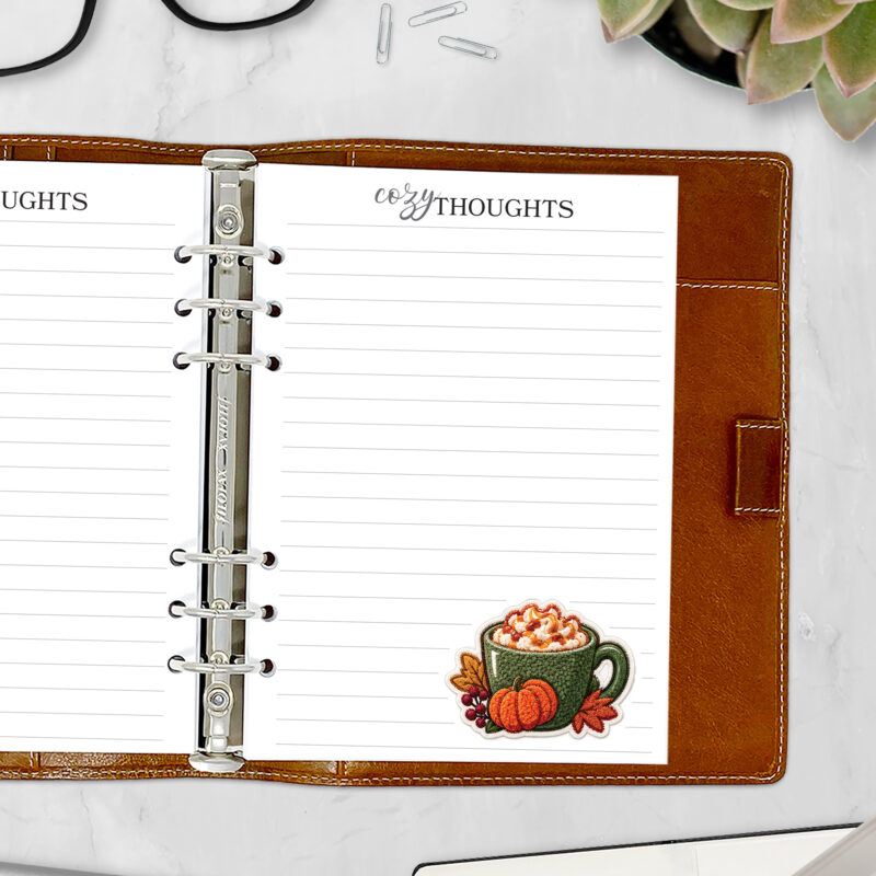 Fall planner insert page with a green chenille-style latte mug, a plush pumpkin, and red berries in the corner