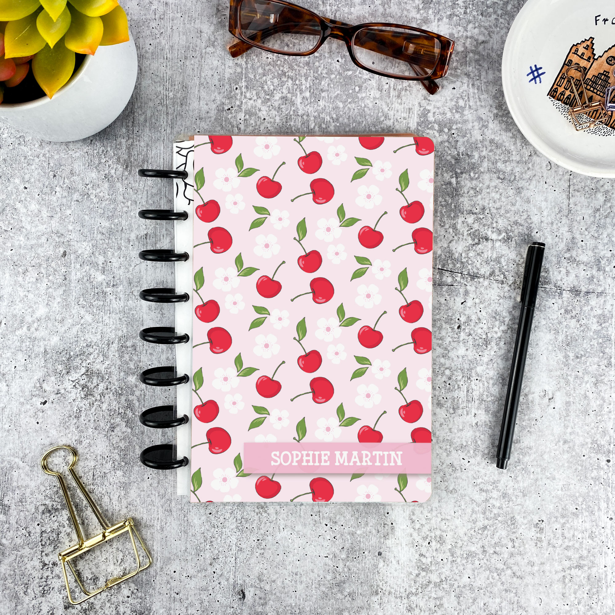 Personalized disc bound password book in cherry pattern with laminated cover, black discs, and custom name