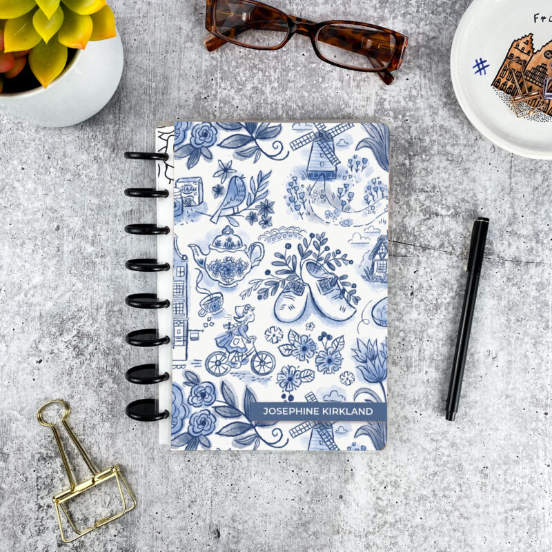 Personalized disc bound password book in dutch delft pattern with laminated cover, black discs, and custom name
