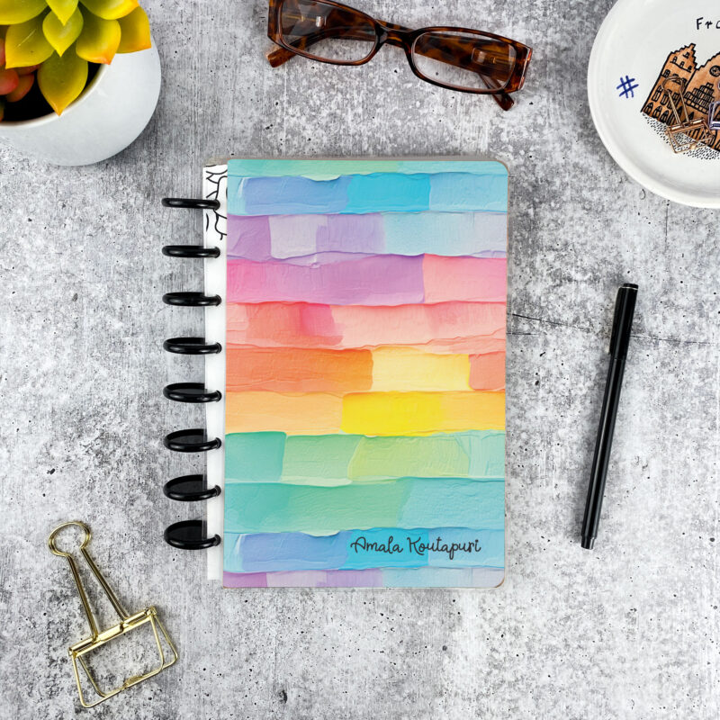 Personalized disc bound password book in pastel frosting pattern with laminated cover, black discs, and custom name