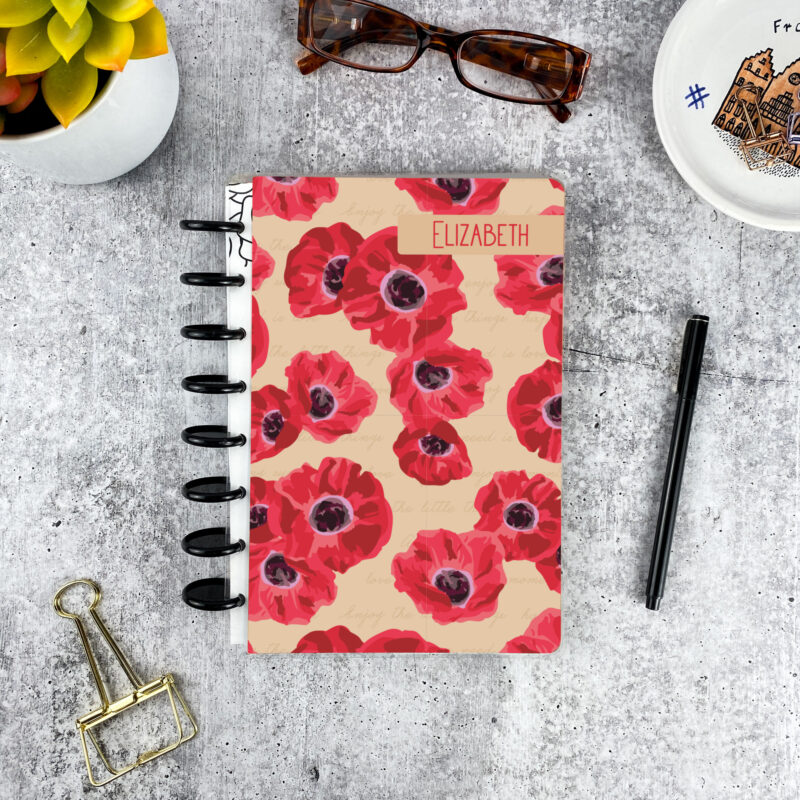 Personalized disc bound password book in red poppies pattern with laminated cover, black discs, and custom name