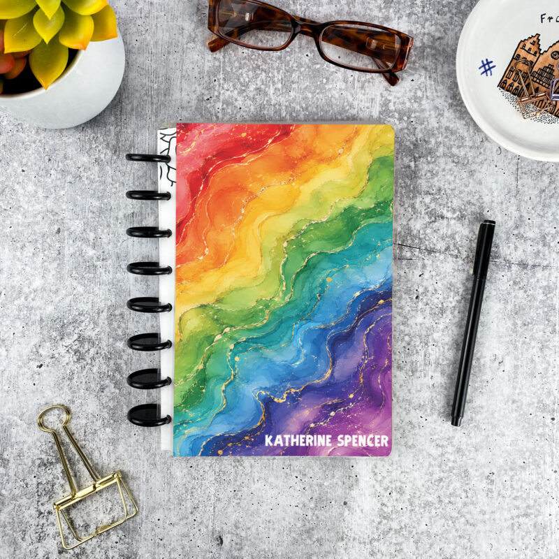 Personalized disc bound password book in rainbow geode pattern with laminated cover, black discs, and custom name